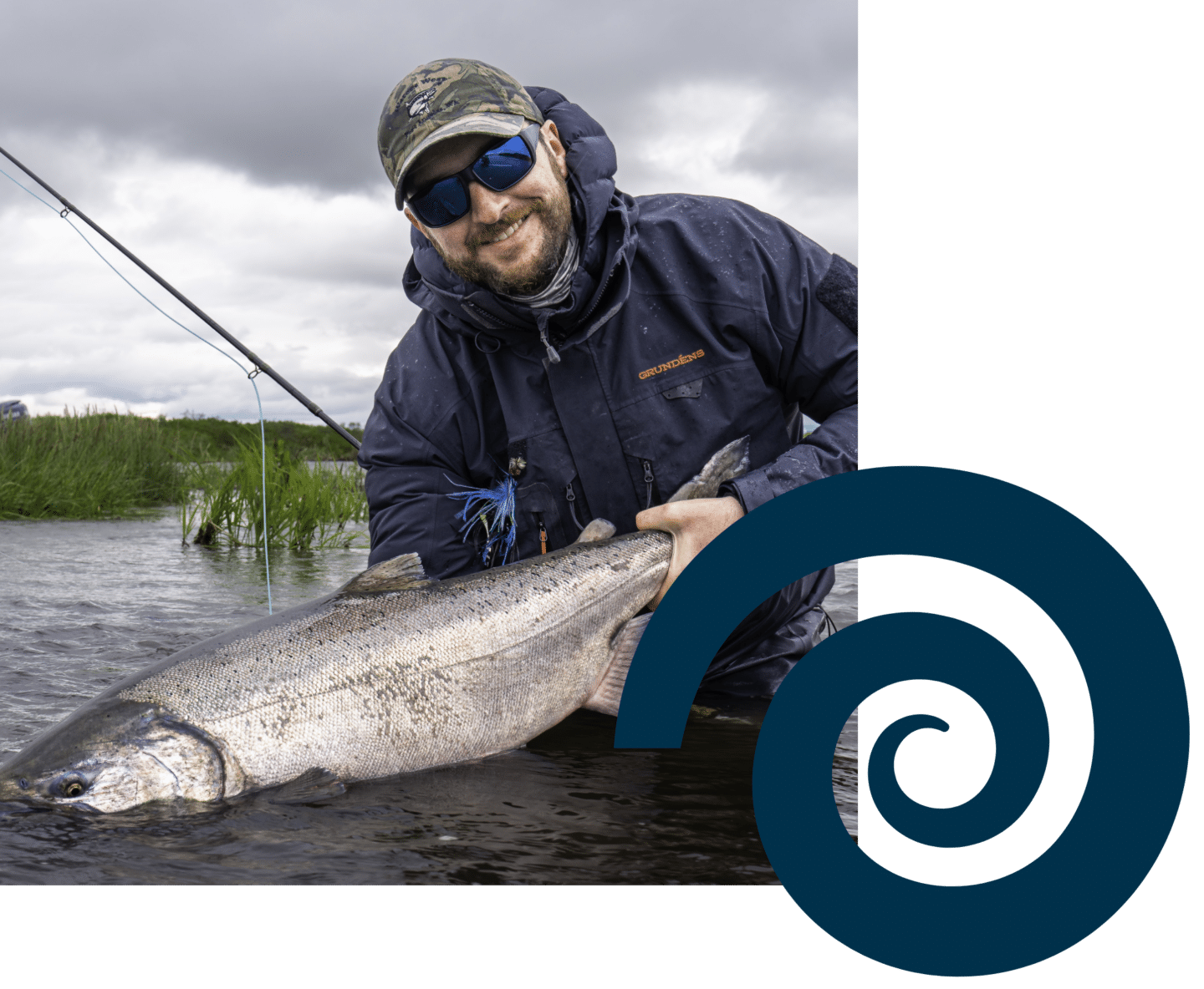 Fisherman holding trophy salmon caught on Alaska river