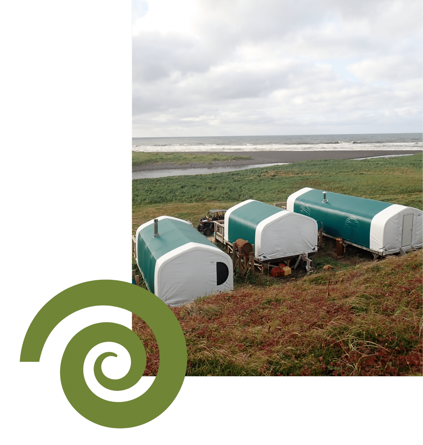 Canvas cabins with green roofs at remote Alaska fishing camp by the ocean